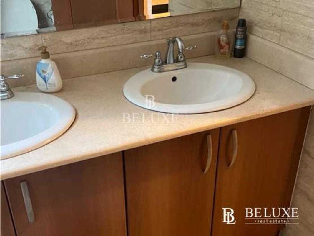 Contemporary bathroom with double sink vanity, beige stone countertop and chrome fixtures PH Amador Hill