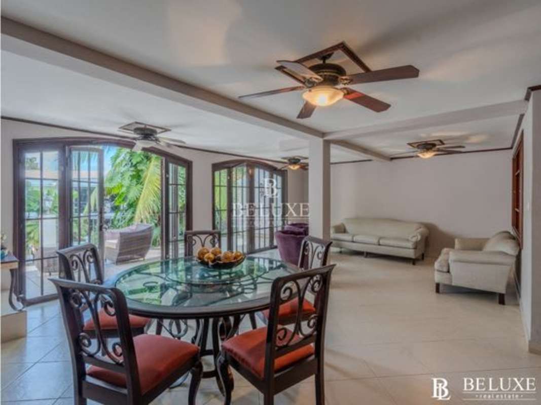 Open plan dining and sitting room with glass doors in duplex house El Cangrejo Panama