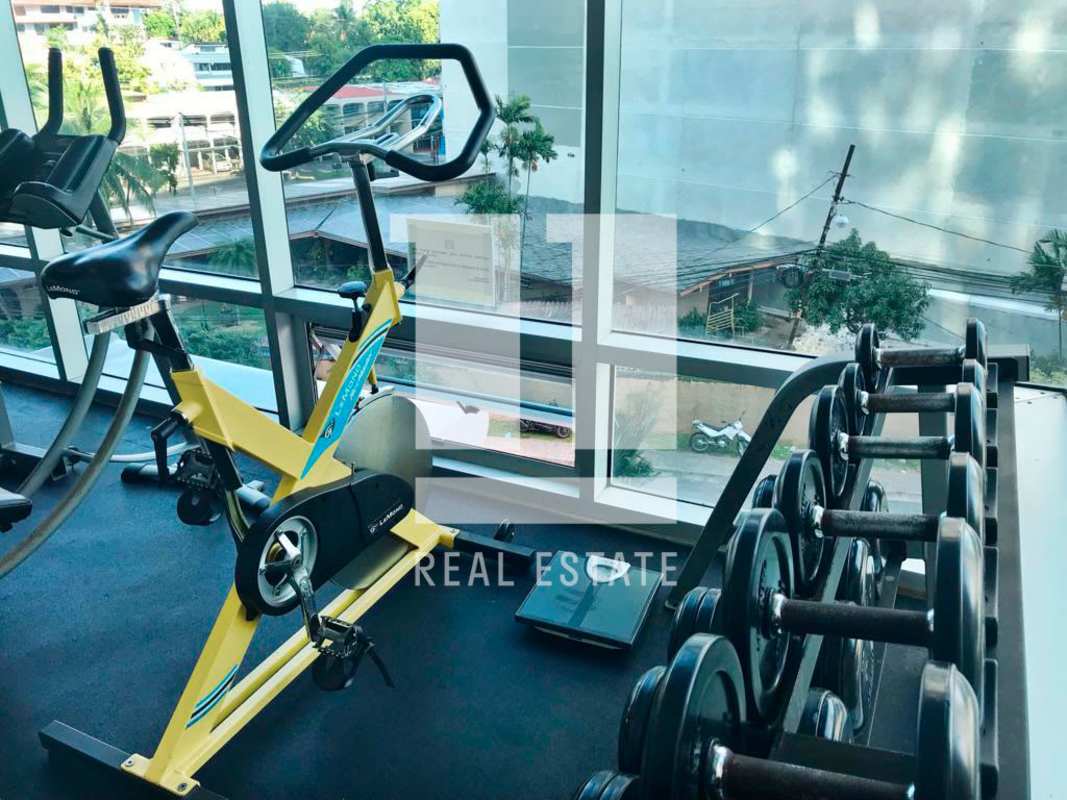 Kitchen with wood cabinetry granite countertop appliances Veranda Tower Panama apartment sale