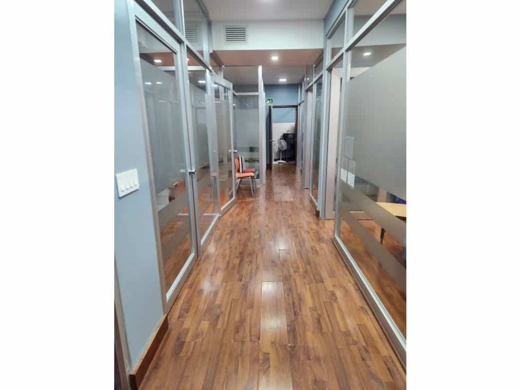 Commercial office corridor with glass partitions wooden floor PH Balboa Plaza Panama City