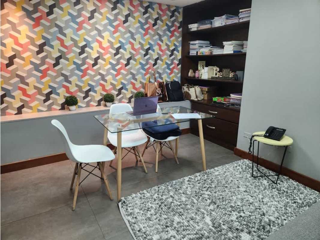 Commercial office or study with geometric accent wall glass table and shelves Panama City