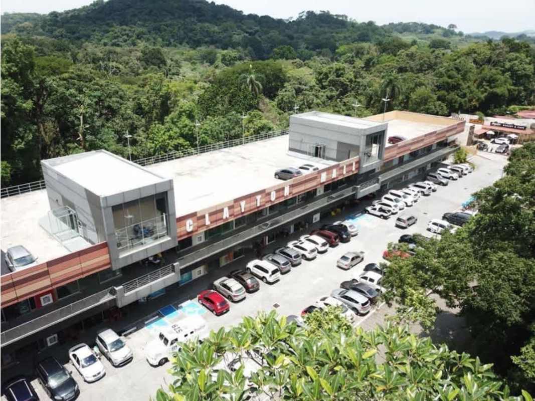 Modern commercial center with rooftop, parking lot, surrounded by lush green areas in Clayton Ancón Panama