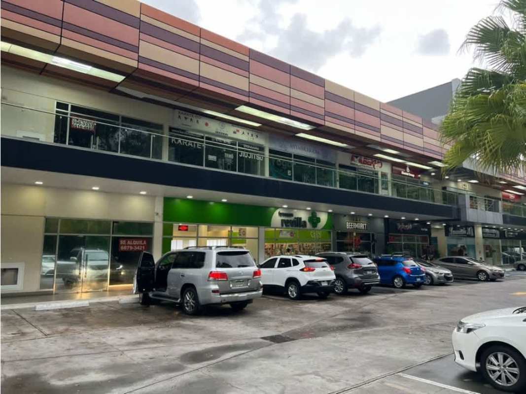 Aerial of modern commercial shopping plaza surrounded by green areas in Clayton Ancón Panama