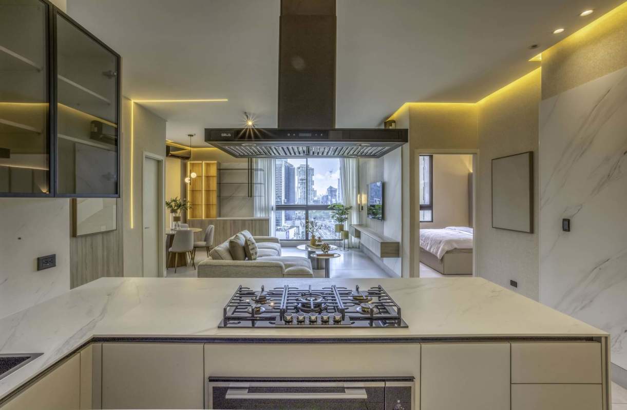Modern open-concept living room and marble kitchen overlooking skyline PH Paitilla Tower Panama City