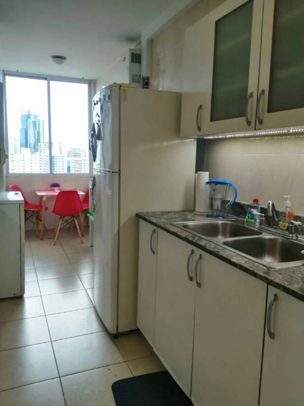 Kitchen with dining table and large window city view in PH Cangrejo 507 Panama City