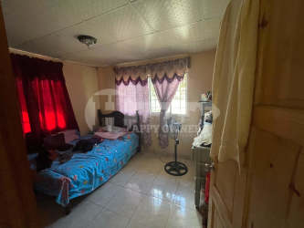 Modest bedroom with tiled floor and natural light Atalaya Veraguas Panama for sale