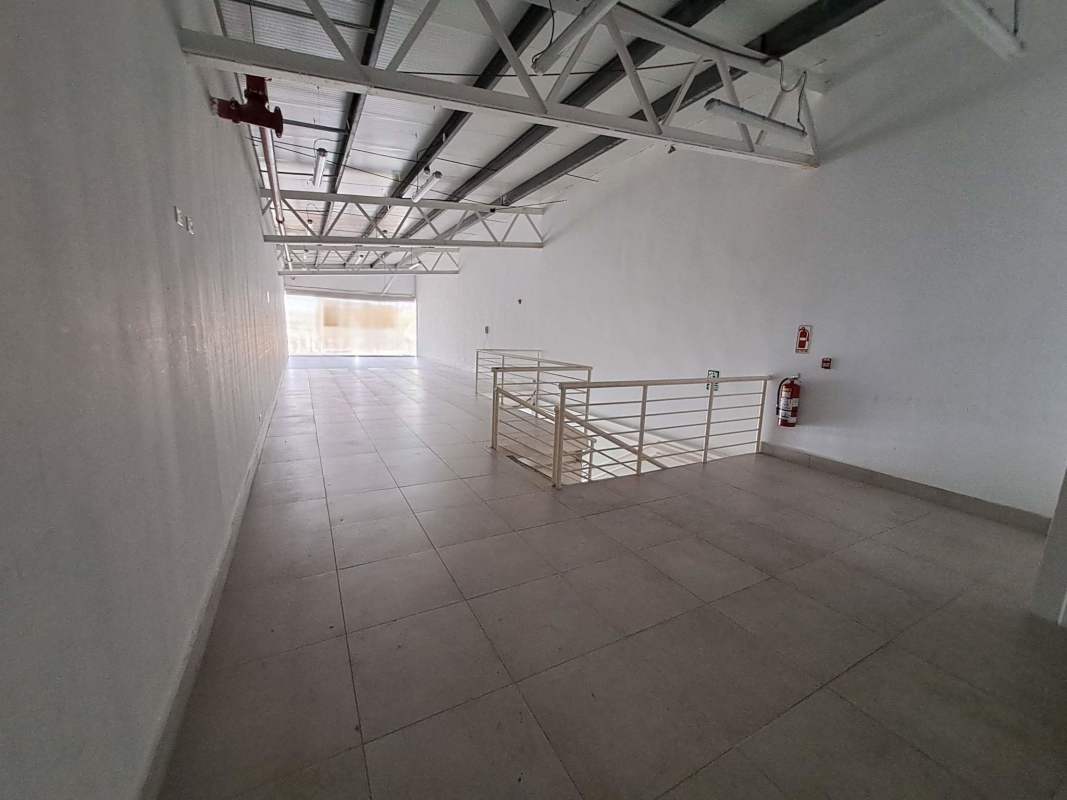 Empty mezzanine level with large windows tiled floors industrial ceiling Plaza Llano Bonito Panama City