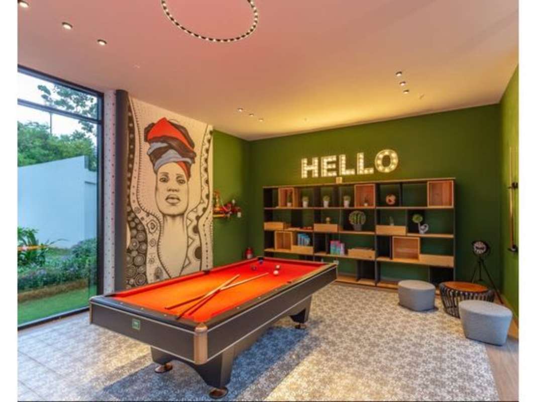 Bright bedroom with floor-to-ceiling window and accent wall at PH Country Club Costa del Este Panama