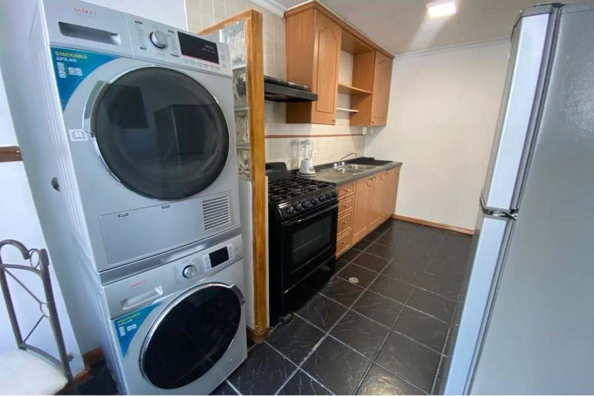 Contemporary kitchen with wooden cabinetry, washer dryer unit at PH Torres Mar del Sur Panama City