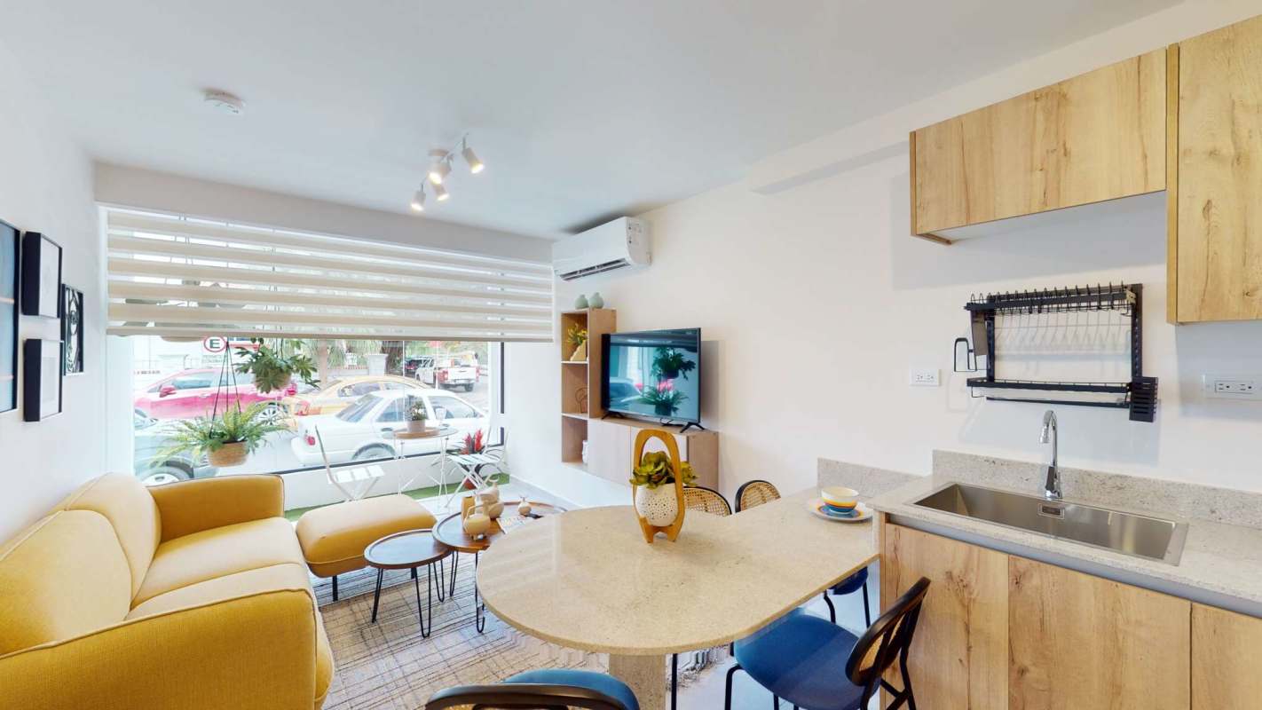 Modern apartment kitchen open to dining at PH Armonía Bella Vista Panama City