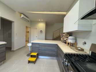 Open plan living room with large sliding doors to terrace in Villa Mar Casamar beachfront duplex Panama