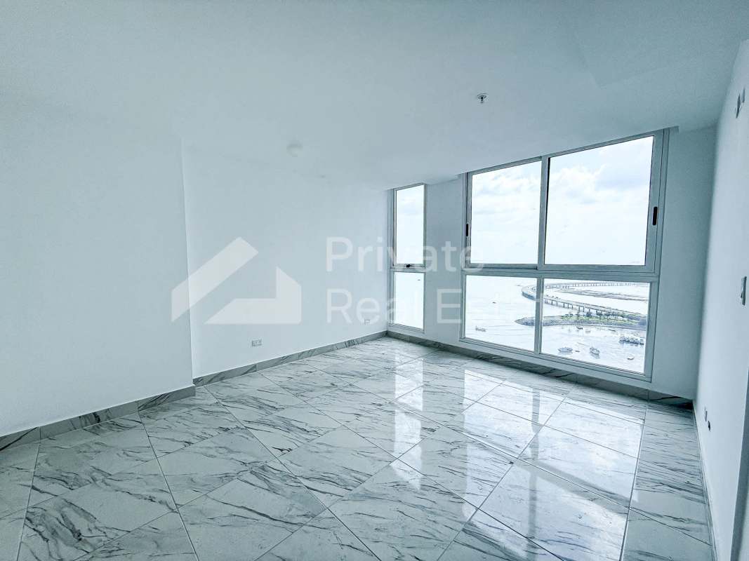 Minimalist living room with marble tiles, large sea-facing windows in PH The Sands Panama
