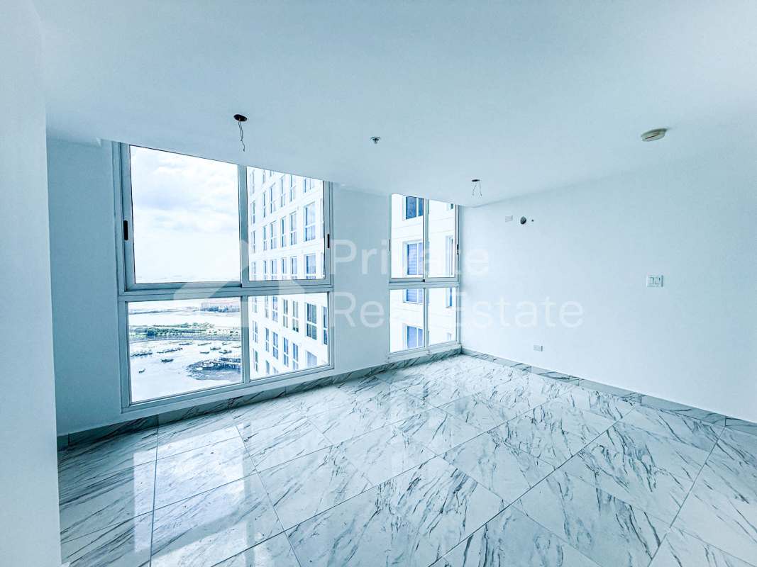 Bright living area with panoramic windows and marble floors at PH The Sands Panama City