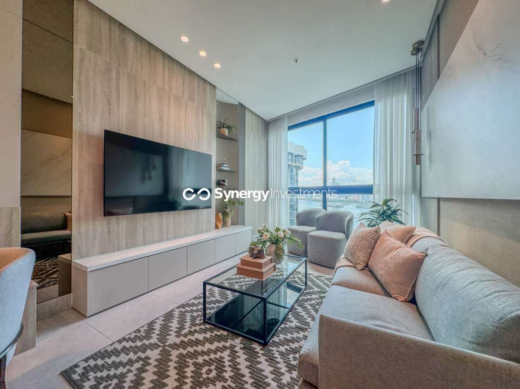 Spacious living and dining area with large windows overlooking city and sea PH Paitilla Tower Panama