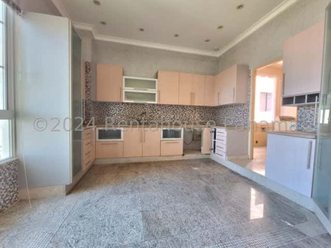 Spacious kitchen with mosaic tile, granite counters, and natural light in PH Terrazas del Parque Panama City