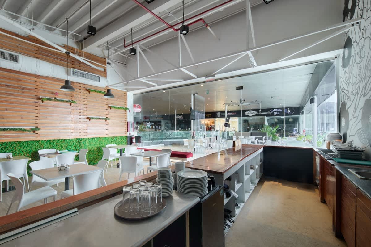 Bright cafe space with wood accents, glass walls, and counter area Balboa Boutiques Panama City