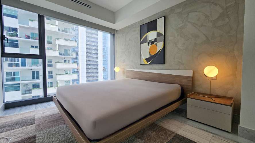 Open concept kitchen with quartz counters and stainless appliances in Allure at the Park Panama