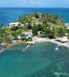 Lush private tropical island surrounded by clear Caribbean ocean waters near Isla Grande Panama