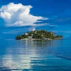 Private island estate with white sand beaches, turquoise Caribbean sea, lush greenery Panama