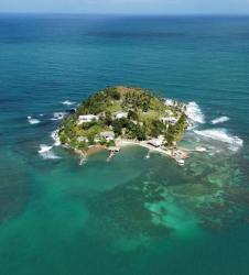 Aerial view of private Panama island with turquoise waters, lush vegetation and sandy beaches