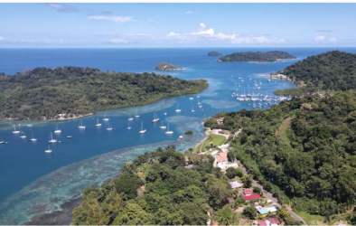 Island marina coastline with boats, ocean views, lush greenery in Caribbean Panama