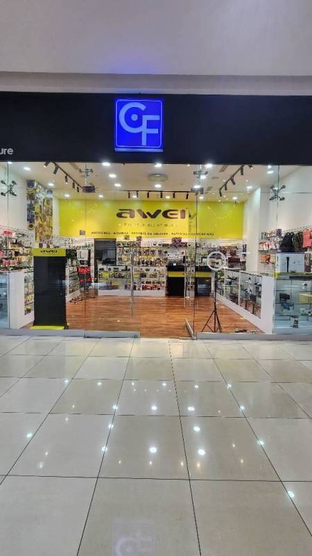 Retail electronics store yellow wall display counters glass frontage at Los Andes Mall Panama