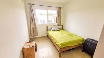 Simple bedroom with bed, large window and closet New West II Costa Verde