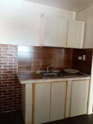 Functional kitchen with backsplash, metal sink, wooden cabinets Villa Nazareth Puerto Caimito