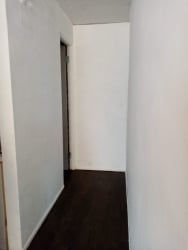 Simple white hallway with dark tile floors Villa Nazareth Puerto Caimito