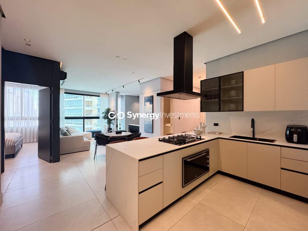 Spacious living and dining area with floor-to-ceiling windows and balcony access luxury apartment in PH Paitilla Tower Panama