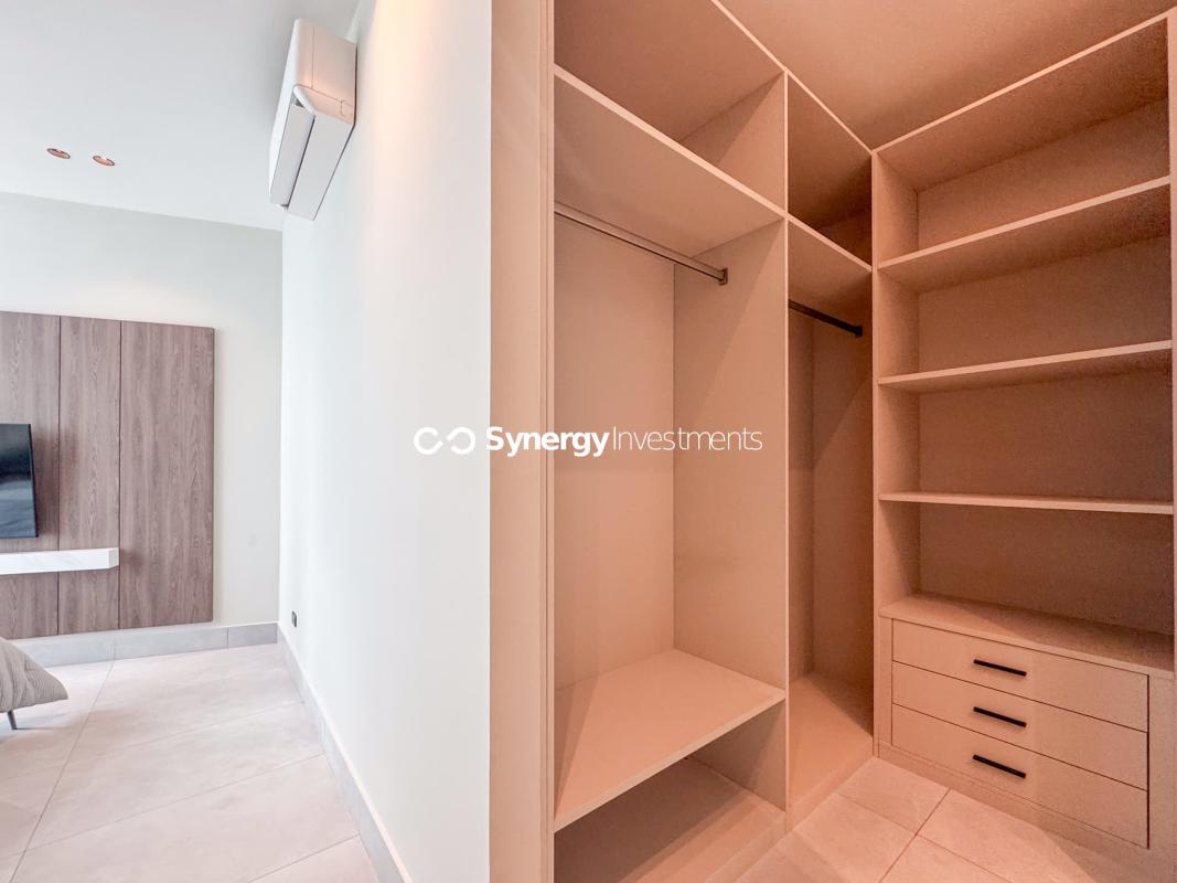 Modern kitchen with marble counters, island, city view window at Sky Point Punta Paitilla Panama