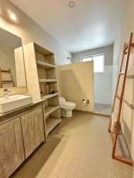 Modern bathroom with shower vanity wood shelves ladder towel rack El Ciruelo Playa Venao Panama