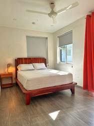 Bathroom with walk-in shower, wood shelves, modern fixtures at El Ciruelo Playa Venao Panama