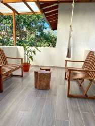 Patio outdoor space wood pergola hammock chair potted plants at El Ciruelo Playa Venao Panama