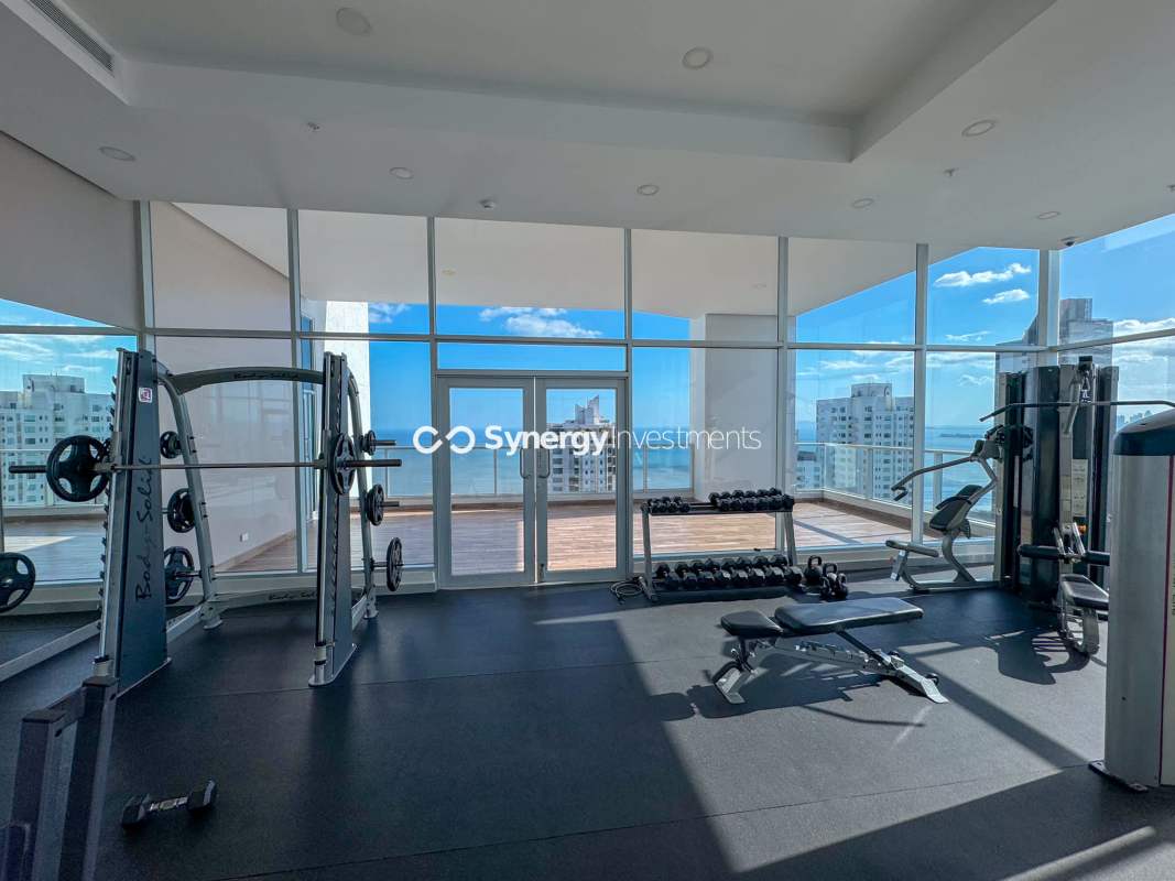 Stylish kitchen with island counter and stainless steel appliances at PH Costa del Este
