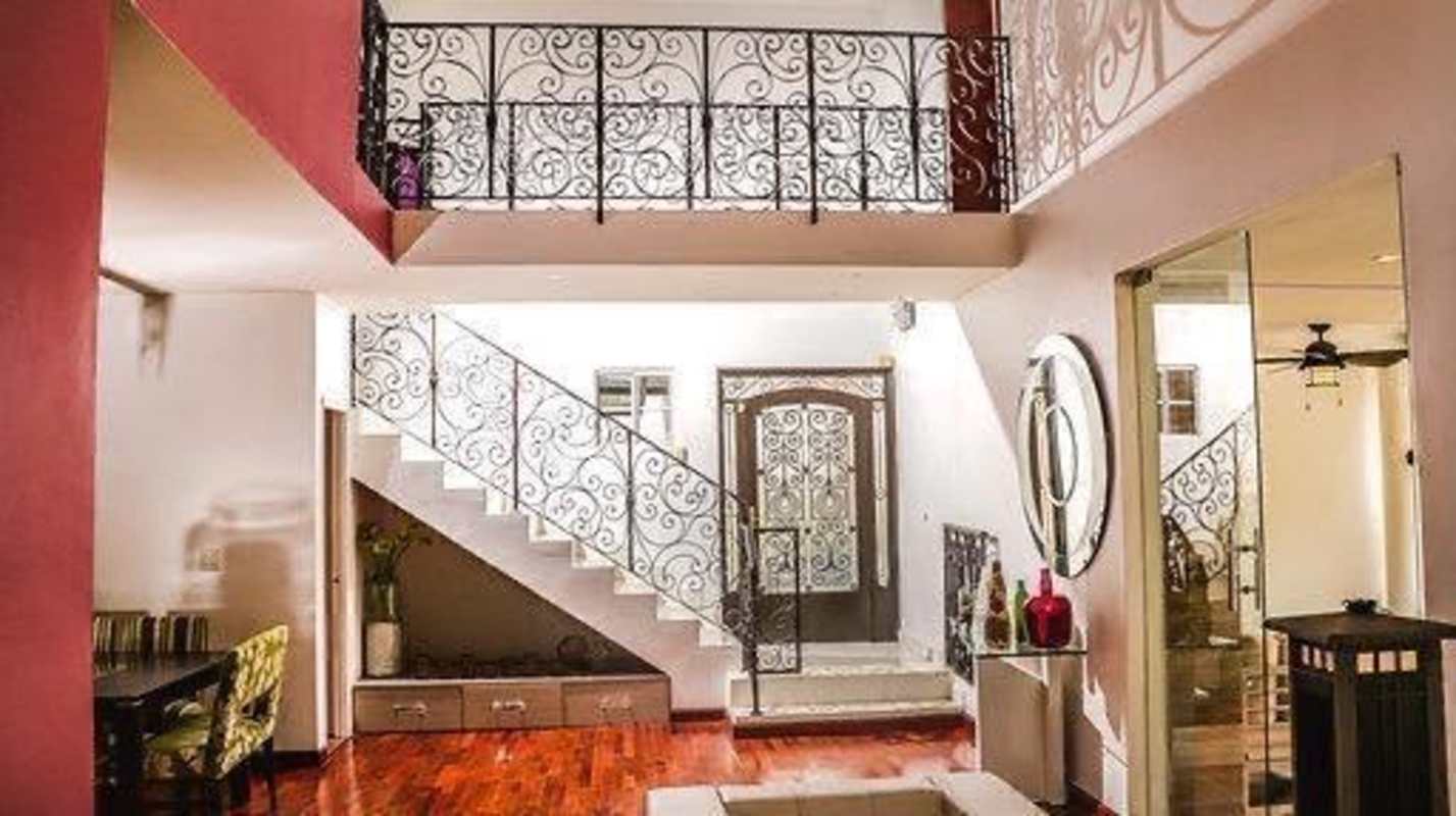 Foyer with wrought iron staircase, balcony overlook and dining area in Fuente del Fresno Panama
