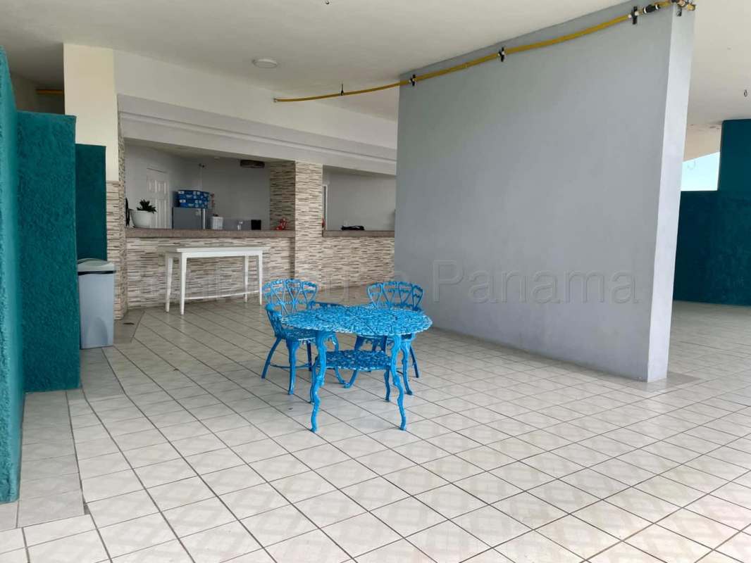 Covered outdoor kitchen with counter and patio dining at PH Beverly Hills Betania