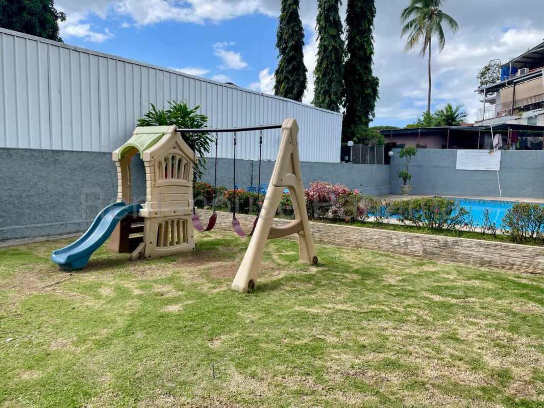 Pool side children's play area with slide and garden at PH Beverly Hills Betania Panama