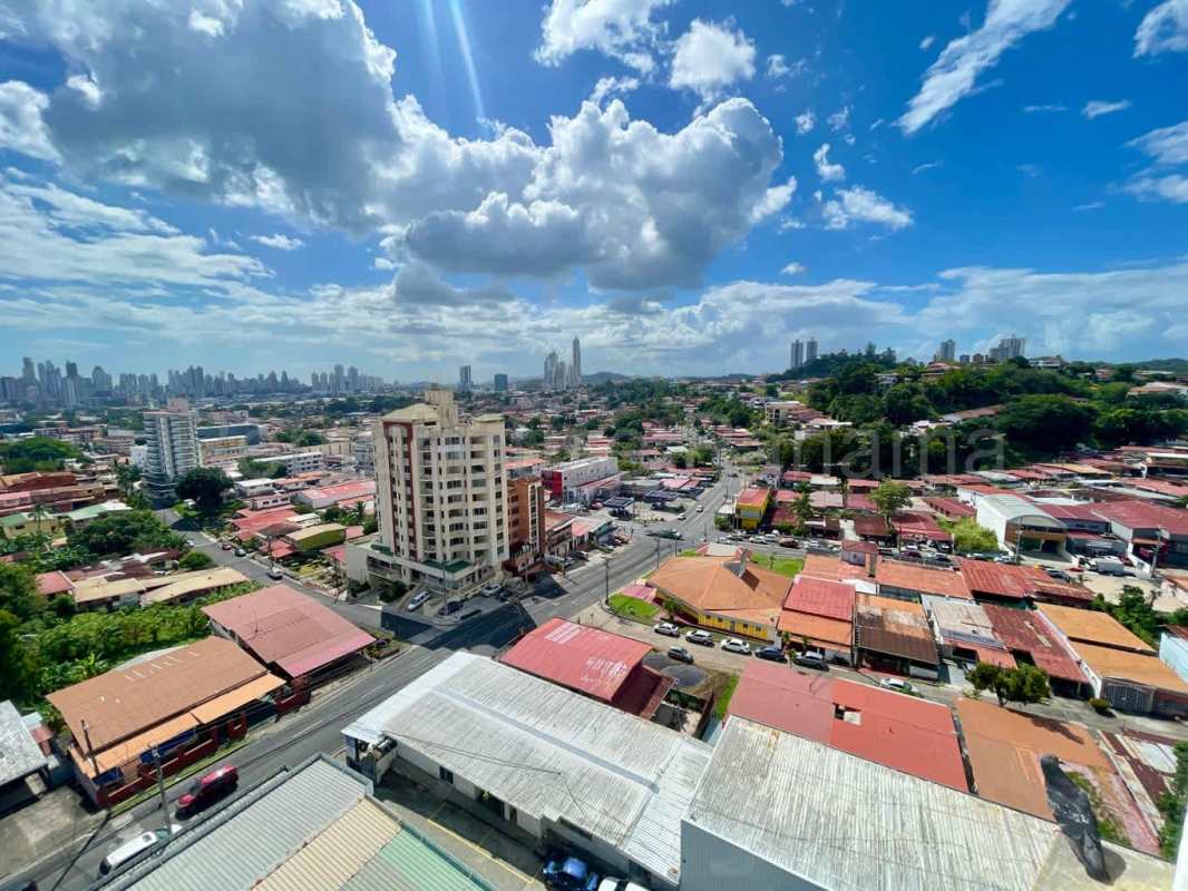 Bright empty living room with tiled floors, ceiling fan, colorful accent wall in PH Beverly Hills Betania
