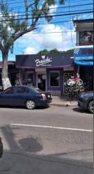Street view of commercial storefronts with colorful facade in Penonomé city center