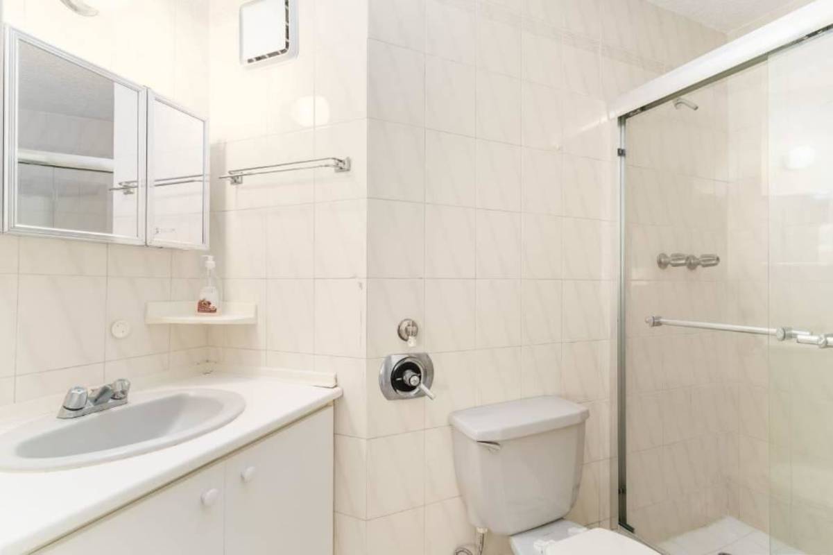 Modern bathroom with glass shower, vanity and window PH EL Cangrejo Tower El Cangrejo Panama City