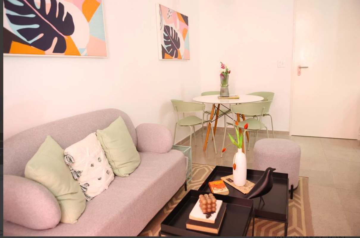 Stylish living room with abstract art, dining area, light gray sofa Casa Korsi Santa Ana Panama