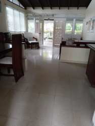 Enclosed veranda patio with large windows garden view Villa Coronado Bouganvillas Panama