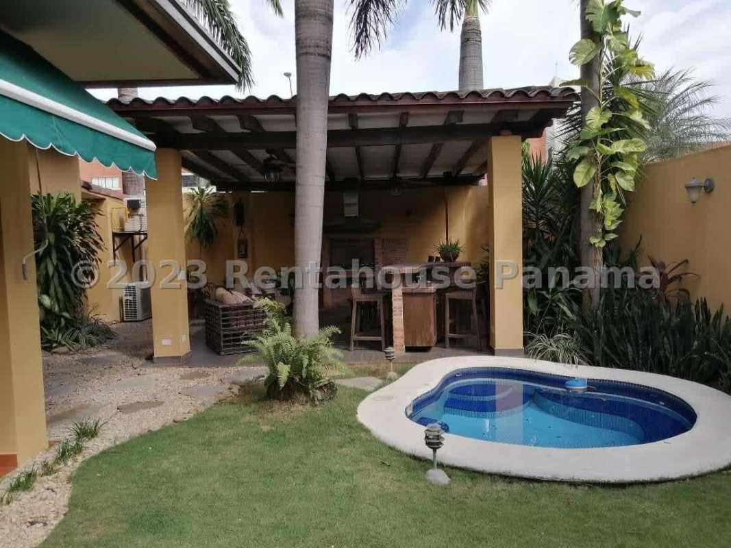 Green lawn with covered patio and tropical landscaping Costa del Este Panama house