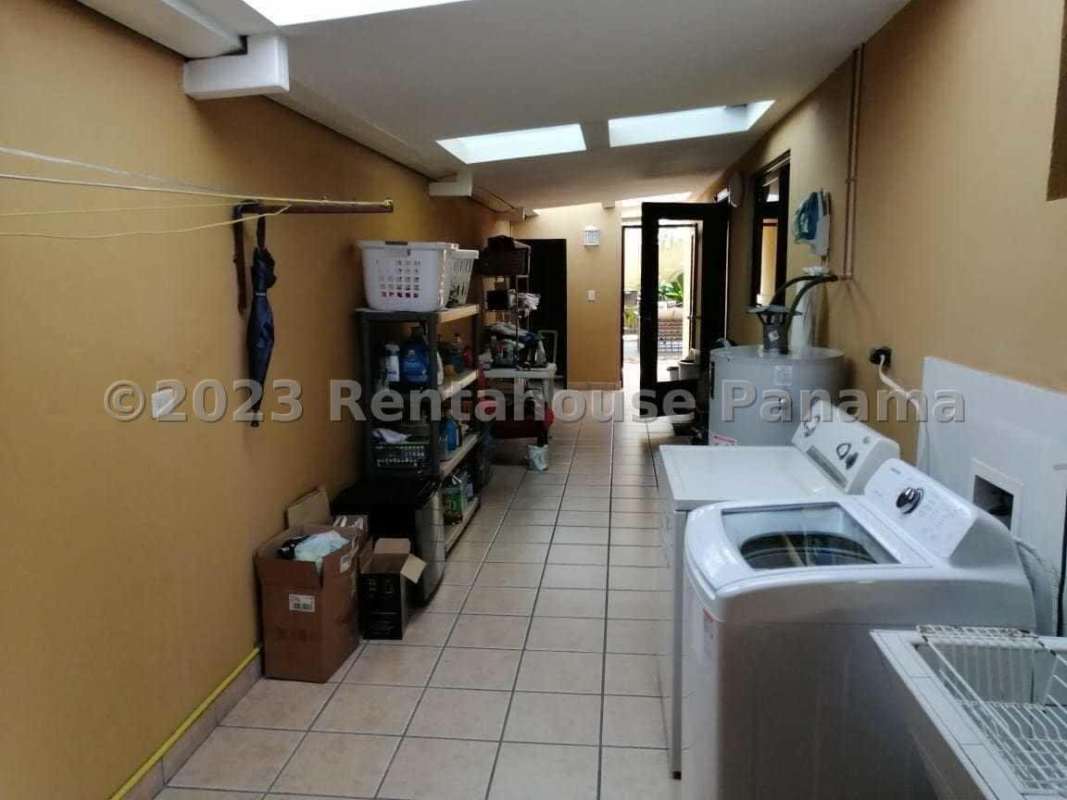 Lush green side yard with tropical plants and patio area Costa del Este Panama