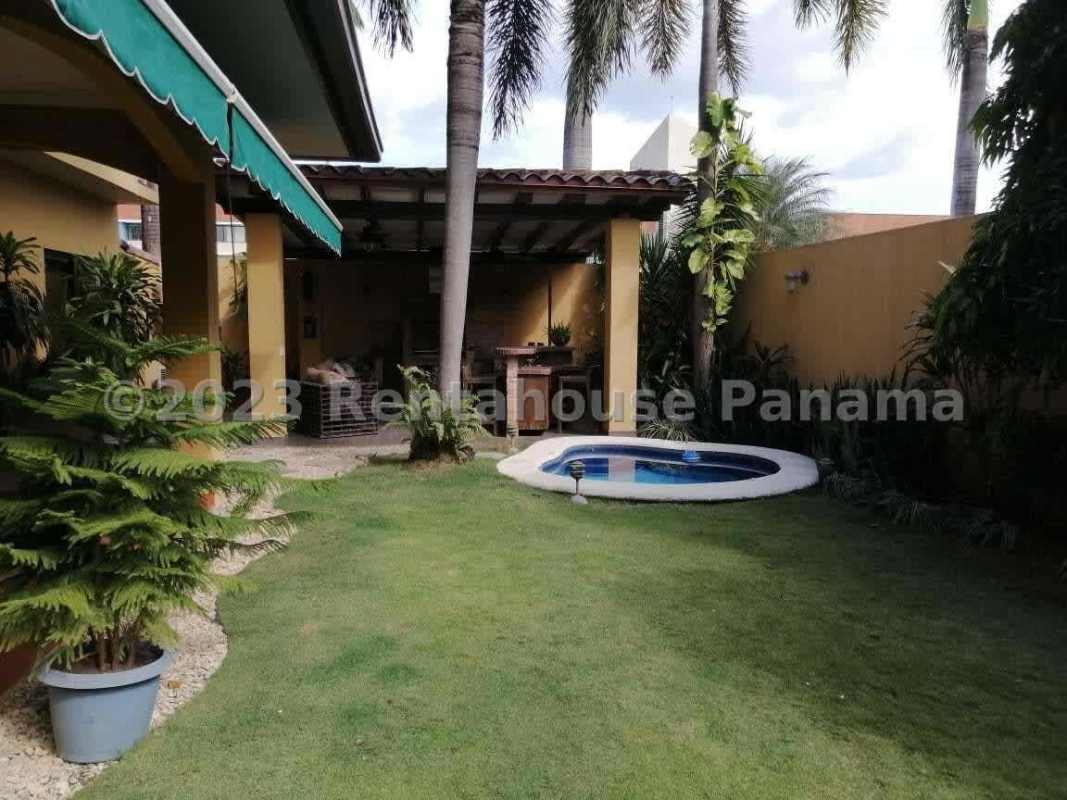 Private backyard with small swimming pool, patio, palm trees in Costa del Este Panama