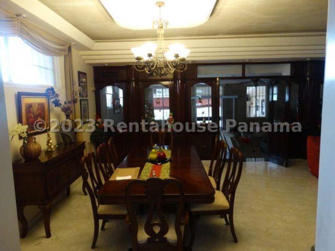 Large living area with yellow sofas, mirrored wall, tile floors in Betania house Panama