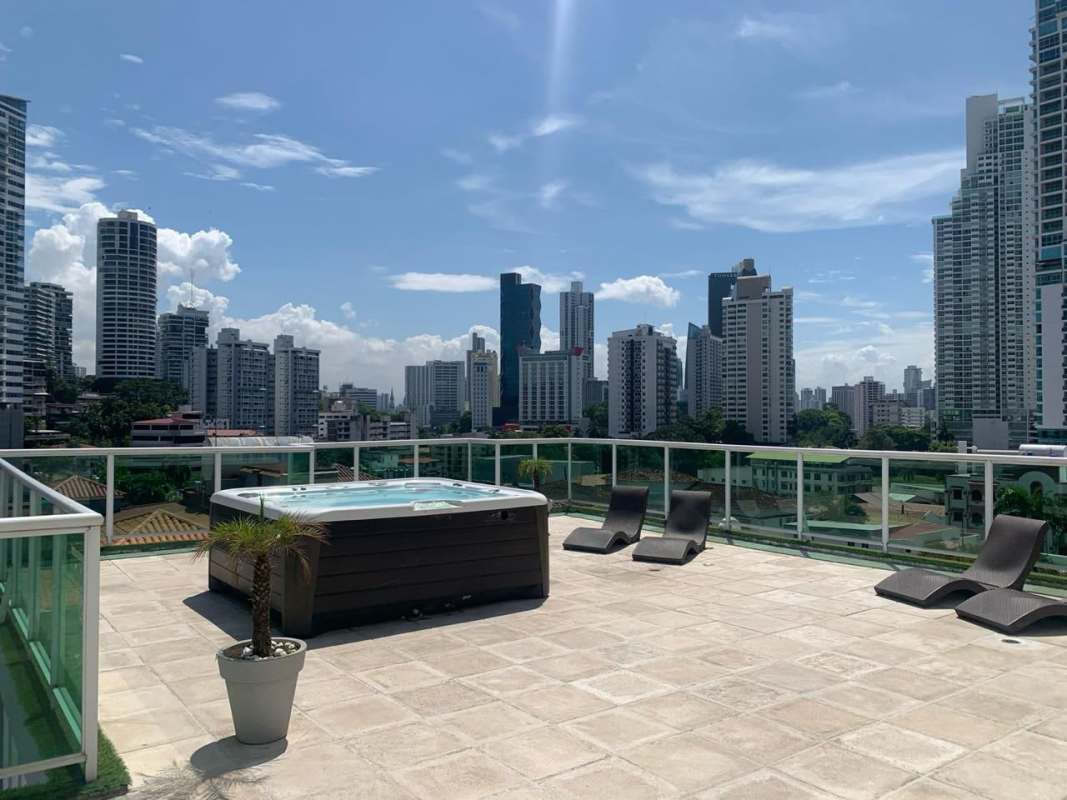 Panoramic rooftop terrace with jacuzzi and lounge chairs city skyline view PH Bela Vita Panama City