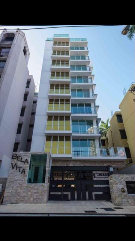Tall apartment tower PH Bela Vita with balconies glass railings in Bella Vista Panama City