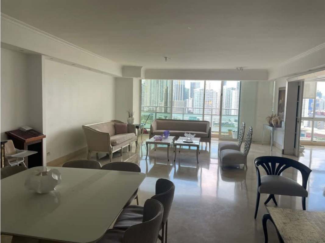 Spacious modern kitchen with island, black countertops at PH Peninsula Punta Paitilla condo Panama